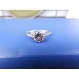 A diamond solitaire, the claw set brilliant weighing approximately one carat (with carbon