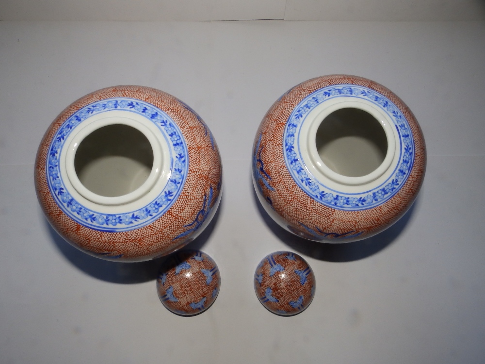 A pair of 20thC Oriental covered vases, 10" high. - Image 2 of 3