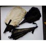 A Victorian black lace parasol - a/f and two ostrich feather fans. (3)