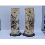 A pair of Japanese Meiji period shibayama inlaid ivory tusk vases, the sides decorated to show