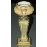 A Royal Worcester vase, in the form of an urn on stand, registered number 301166, puce mark to base,