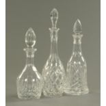 Three cut glass decanters, each with stopper. Tallest 40 cm.