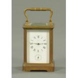 An Edwardian brass cased alarm carriage clock, height excluding carrying handle 10 cm.