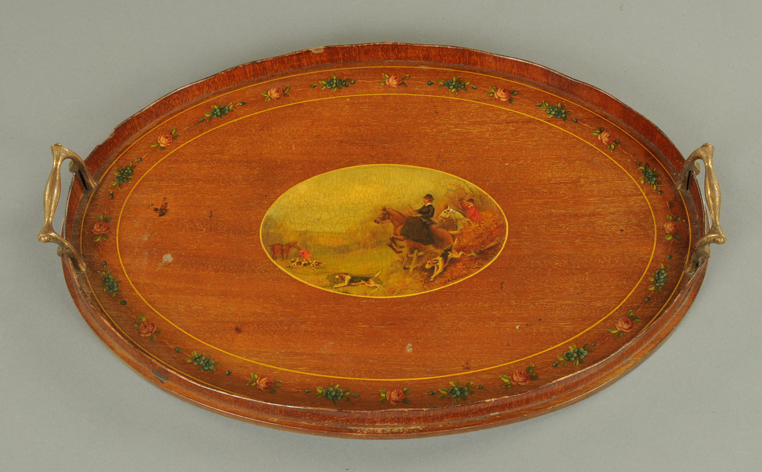 An Edwardian mahogany tray, painted to the centre with a hunting scene and with foliate border.