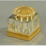 A German cast brass and glass inkwell, early 20th century,