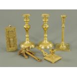 A pair of Victorian brass candlesticks, with push rod ejectors, a single candlestick, chamber stick,