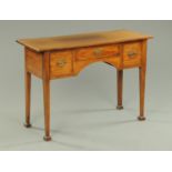 An Edwardian mahogany desk or dressing table, with rectangular top,