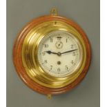 A brass cased ships clock, with subsidiary seconds dial,