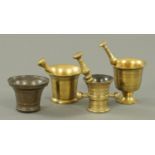 Three antique brass pestle and mortars, and a small bronze mortar. Tallest 12 cm.