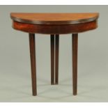 A George III mahogany demi-lune turnover top tea table, raised on legs of tapering square section.