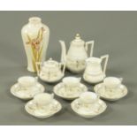 An Edwardian china dolls tea set, and a baluster vase, height 14 cm.