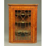 A Georgian inlaid mahogany hanging corner cupboard, with ebonised and boxwood astragals,