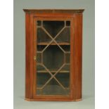 A 19th century mahogany hanging corner cupboard,