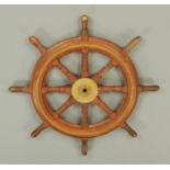 A brass bound ships wheel, by McTaggart, Scott & Co. Ltd., Edinburgh.