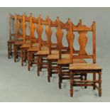 A set of eight oak reproduction splat back dining chairs,