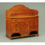 A Victorian fruitwood washstand, with tall splash back and fitted with a series of drawers,