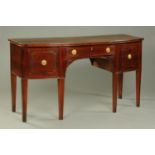 A George III mahogany bowfronted sideboard, with slight relief moulding to the drawer fronts,
