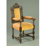 A late 19th century carved oak armchair, with upholstered back,