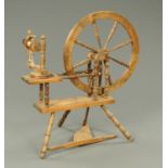 A spinning wheel, with turned spokes and supports. Height 99.5 cm.