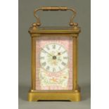An Edwardian brass carriage clock, with pompadour pink porcelain panels, timepiece only.