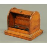 An Edwardian oak tambour topped stationery cabinet, and combined pen stand, width 29 cm.