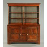 A Georgian oak dresser with Delft rack, the rack with moulded cornice above a series of shelves,