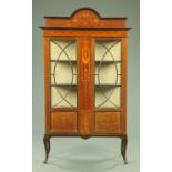 An Art Nouveau inlaid mahogany display case, with rear arched pediment,