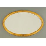 An Edwardian oval gilt framed mirror, with bevelled glass. Width 92 cm.