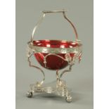An Edwardian cranberry glass bowl, housed in a plated stand. Height excluding carrying handle 13.