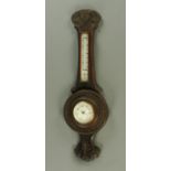 An early 20th century oak cased aneroid barometer, height 84 cm.