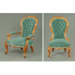 A pair of Victorian walnut ladies and gentleman's chairs, with exposed scroll carved showframes,