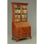 A George III inlaid oak bureau bookcase, with moulded cornice above a pair of glazed doors,