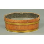 An oak wine cooler, oval, brass bound, bearing plaque "Made from Battleships of Britain".