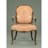 A French walnut open armchair, with moulded showframe, upholstered back,