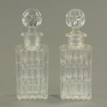 A pair of cut glass whisky decanters, square form, each with stopper.