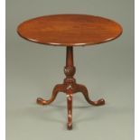 A George III mahogany tripod table, with circular top and turned and carved column. Diameter 81 cm.