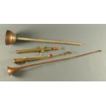 A copper post horn, brass post horn, copper dolly and sprayer.