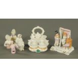 A Victorian fairing inkwell, a faring "Who is Coming?", and four pin cushion ladies.