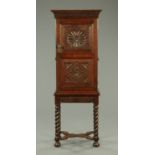 An antique oak cupboard on stand, narrow form,