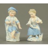 A pair of German porcelain figurines, boy and girl seated, each bearing letter "R" to base.