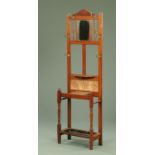 An Edwardian walnut hall stand, with mirror, tiles and shelf. Width 55 cm.