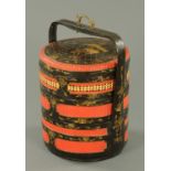 A Chinese stacking cylindrical food basket, black, red and gilt painted. Diameter 34 cm.