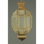 A glass and pressed metal lantern. Height +/- 57 cm.