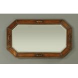 A 1930's dark oak framed mirror, with bevelled glass with beaded decoration and turned pilasters.