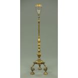 A brass lamp standard, raised on Portuguese style scroll legs.