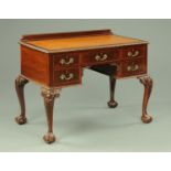 A mahogany desk, circa 1930 with rear upstand and gilt tooled leather writing surface,