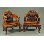 A pair of late 19th/early 20th century Japanese carved wooden armchairs,