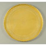 A large Eastern brass engraved and embossed tray. Diameter 58 cm.