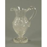 A 19th century cut glass jug, with loop handle, swag cut and with circular star cut base,