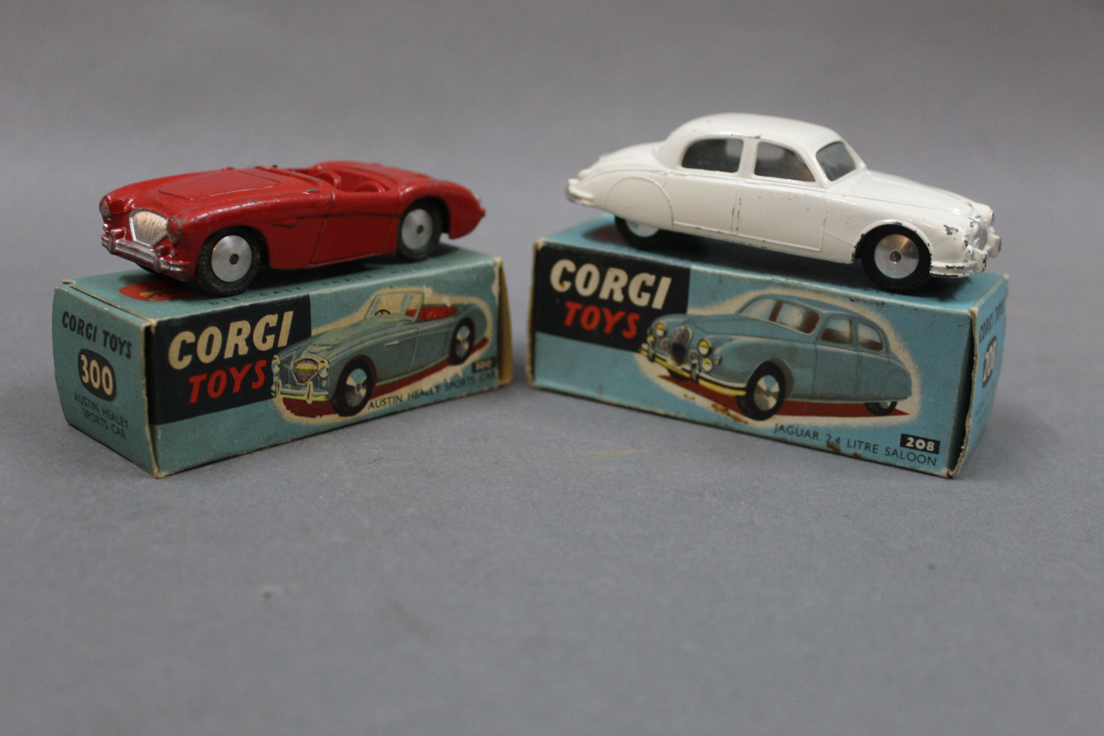 2 Corgi diecast model vehicles, both displayed in blue picture boxes: A Jaguar 2.